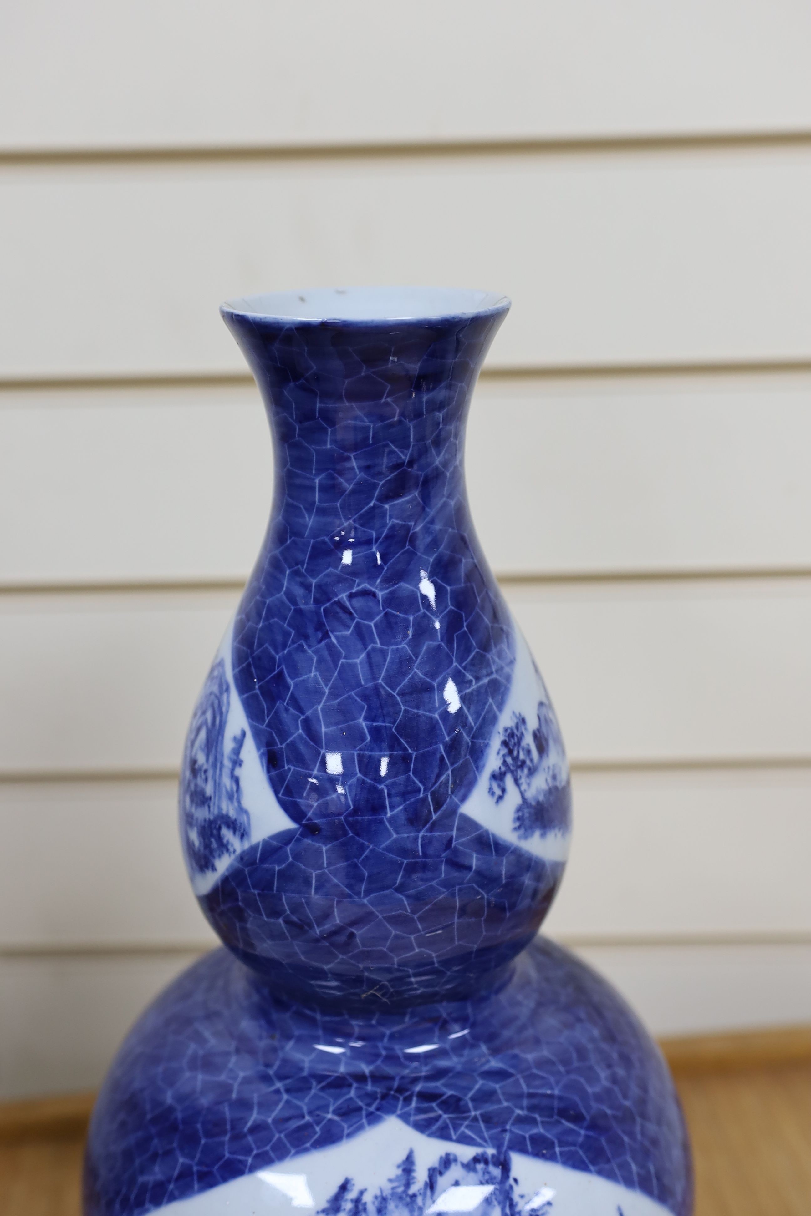 A Chinese blue and white gourd vase with landscape decoration, a similar blue and white sleeve vase and a Japanese Kutani vase